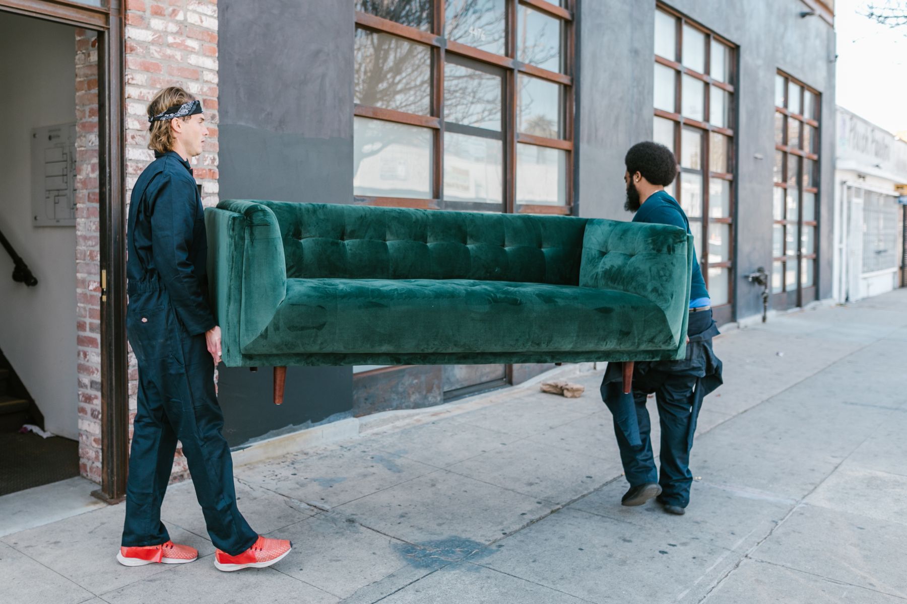 A local hauling crew carrying a sofa out of a home